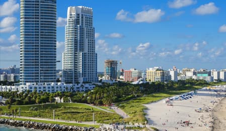 Miami Beach skyline with tall modern residential buildings overlooking the ocean.