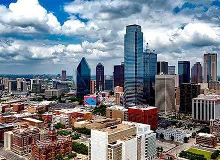 Panoramic aerial view of the Dallas, Texas city skyline with many skyscrapers.