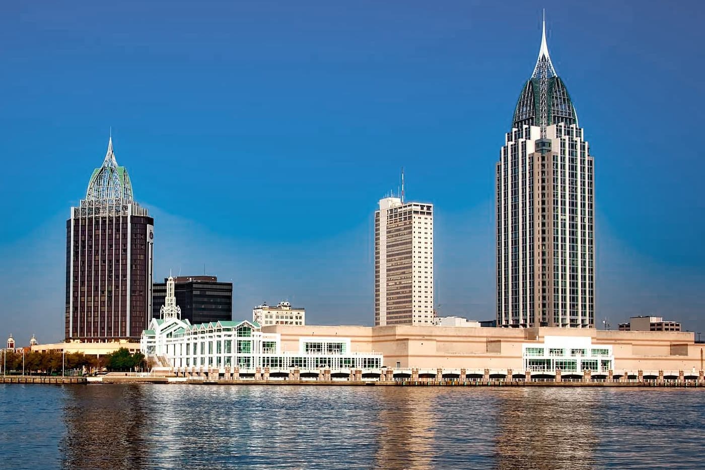 Mobile, Alabama waterfront skyline with distinctive skyscrapers and a white convention center.